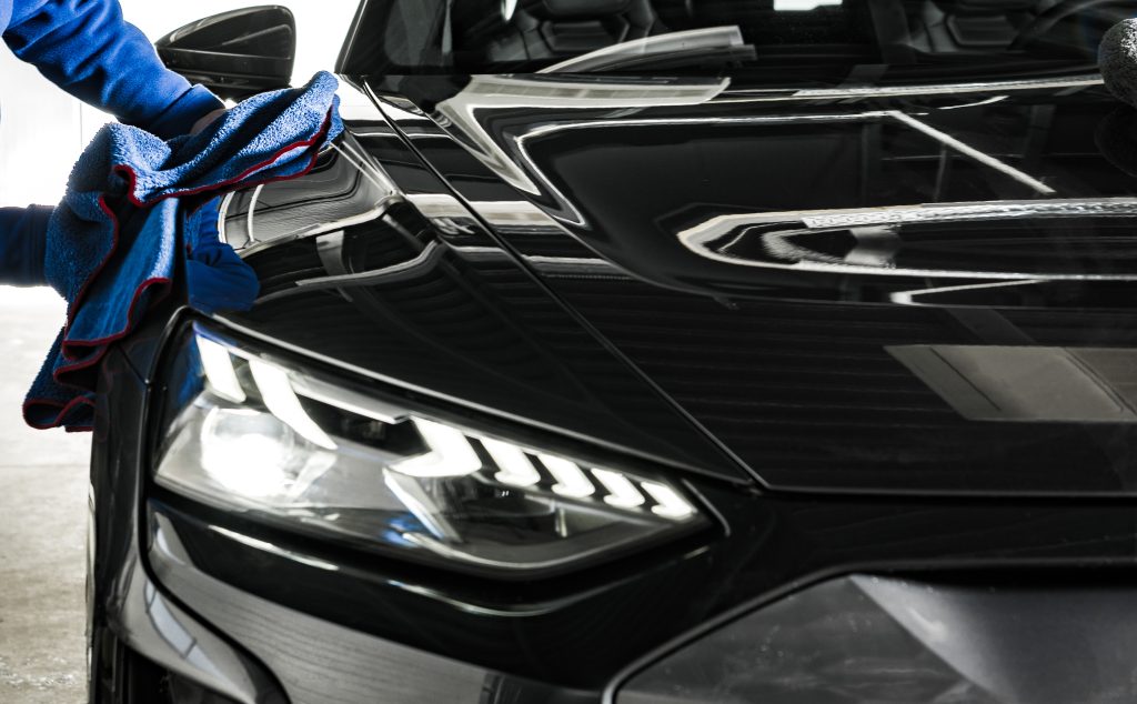 A close-up of a freshly detailed car with a glossy exterior